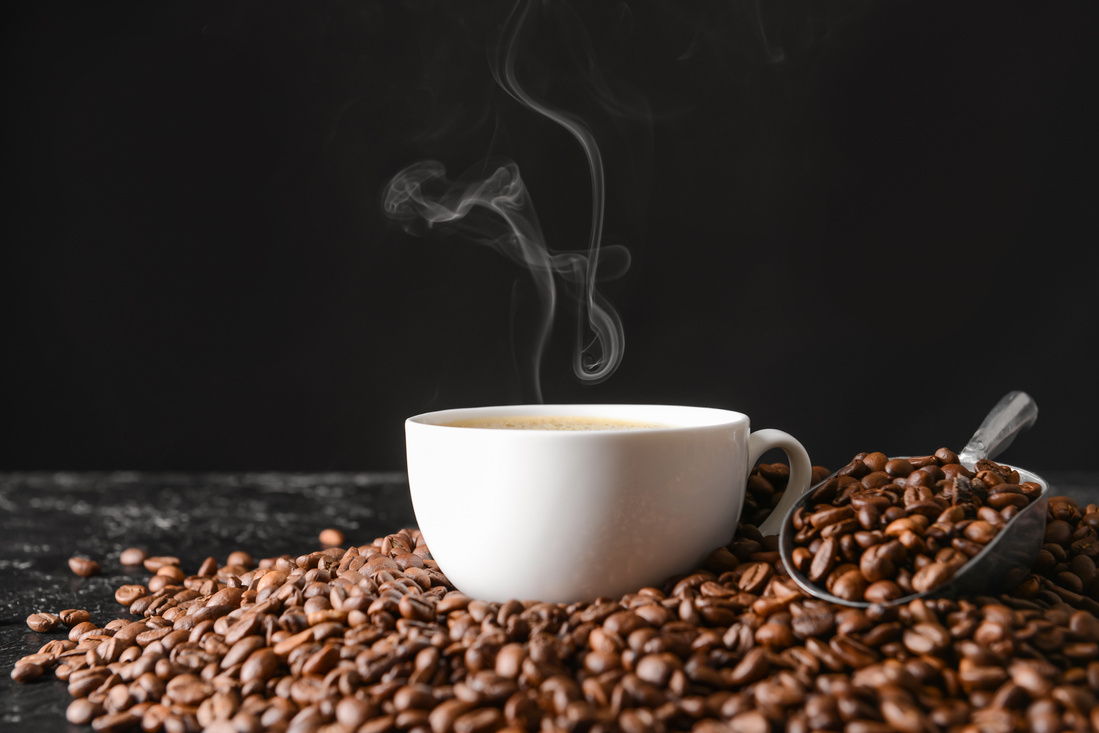 Cup of Hot Coffee and Beans on Table